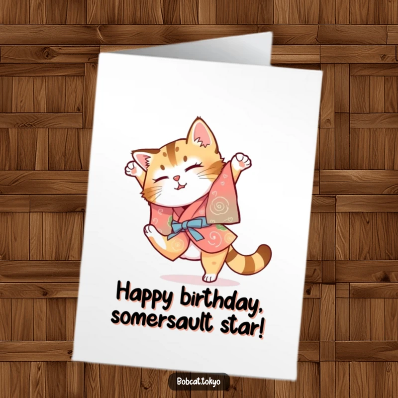 Funny Free Printable Birthday Card: Bobcat in a colorful kimono attempting a clumsy somersault, full of enthusiastic effort.