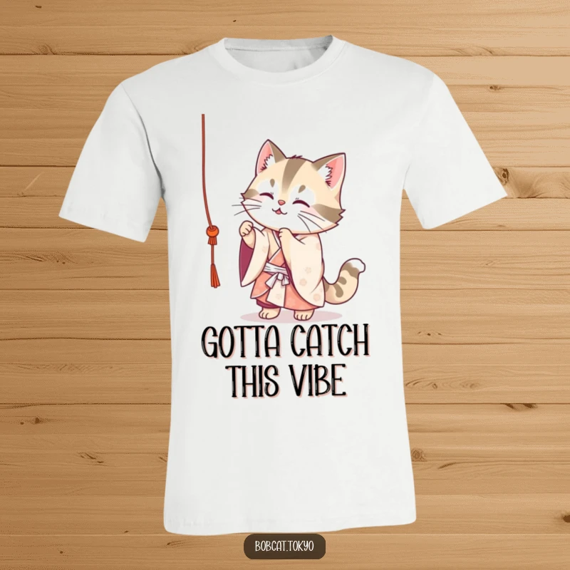 Funny Bobcat T-Shirt: A cute bobcat in a flowing kimono playfully batting at a dangling string, captured in a fun, lighthearted moment.