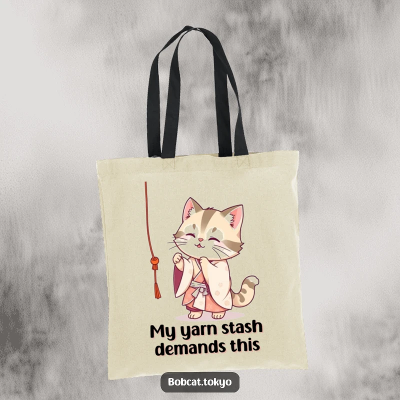 Funny Bobcat Tote Bag: A cute bobcat in a flowing kimono playfully batting at a dangling string, perfect for a fun, whimsical shopper.